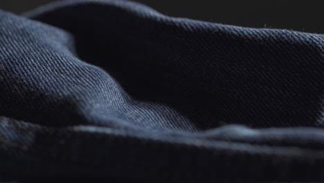 closeup of indigo blue denim fabric during manufacturing process, designer fashion