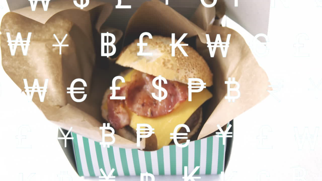 Burger with bacon and cheese in box over currency symbols animation