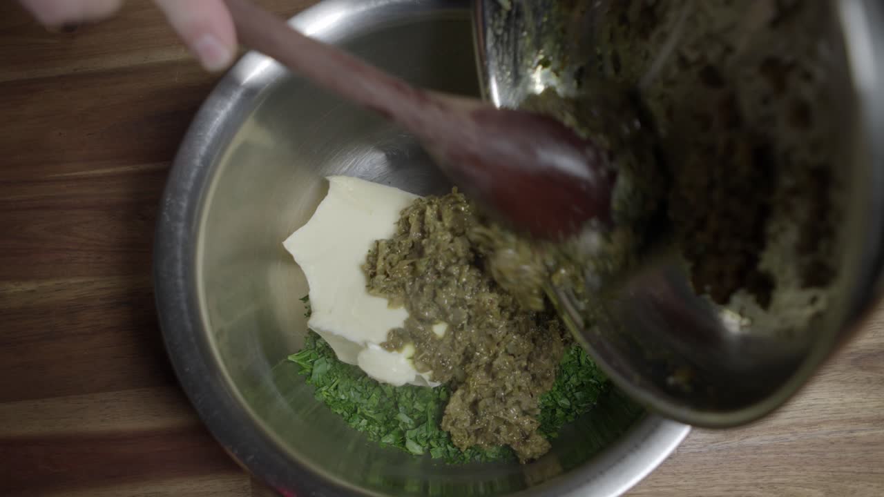 A chef preparing a caf&eacute; de paris sauce