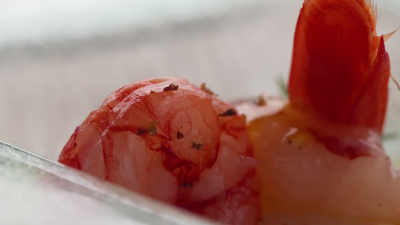 A close-up of olive oil drizzling over shrimp, showcasing a fresh summer seafood dish in Taormina, Sicily, Italy (Taormina, Sicilia, Italia)