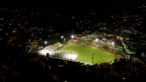 drone circles above baseball stadium at night