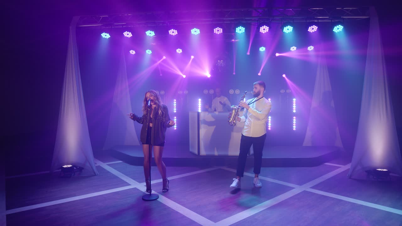 Musical band group of three people playing music song, performing on concert musician light stage