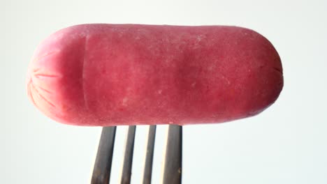 close up of mini sausage against white background