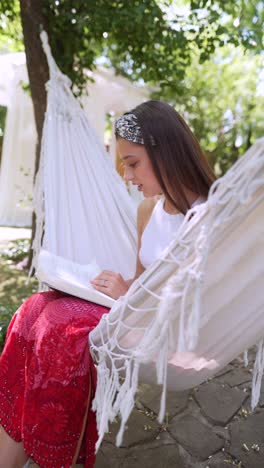 young woman reading in a hammock