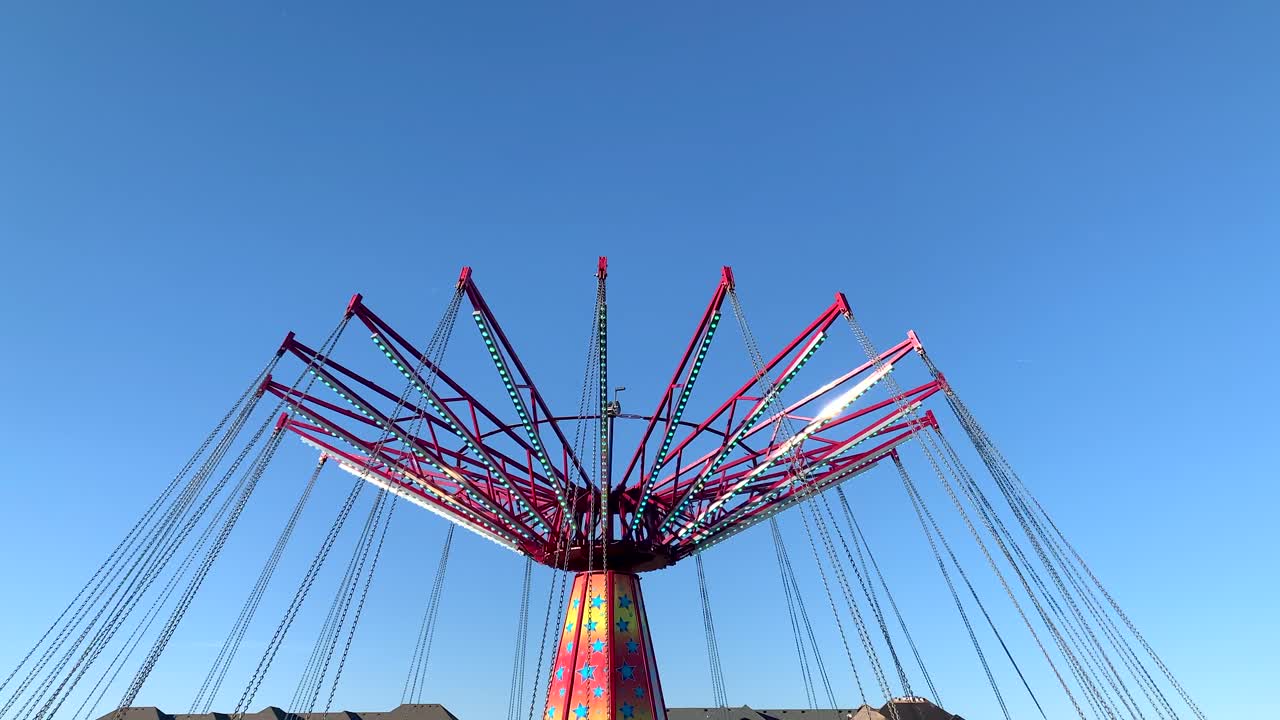 Carnival swing in motion on a sunny day, no person