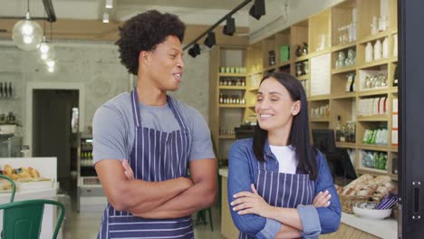 Animation-of-happy-diverse-female-and-male-waiters-at-coffee-shop