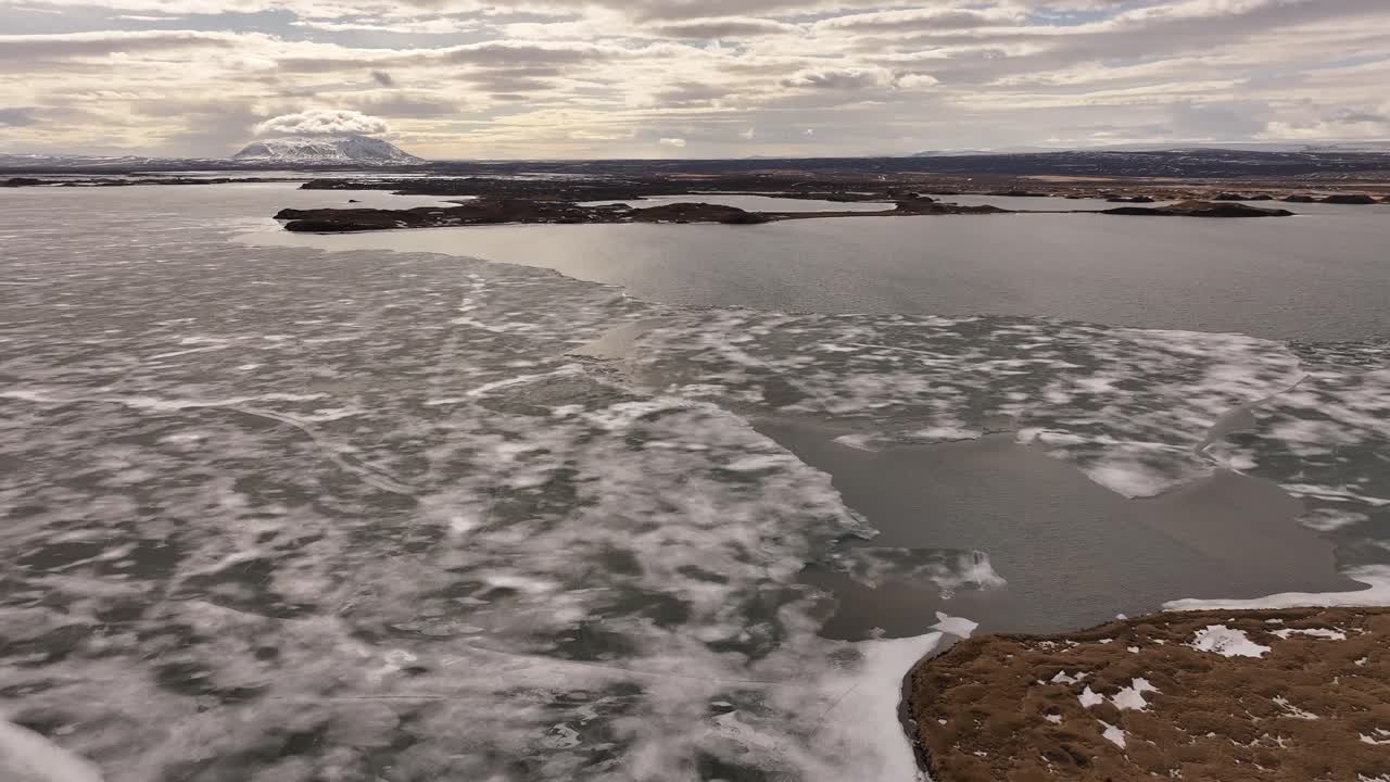 Frozen surface of Lake Mývatn with patchy snow near Skútustaðir and Reykjahlíð. Mývatn, Iceland