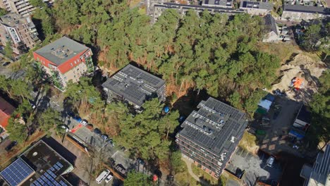 Cinematic-aerial-of-modern-apartment-buildings-with-photovoltaic-solar-panels-on-rooftop