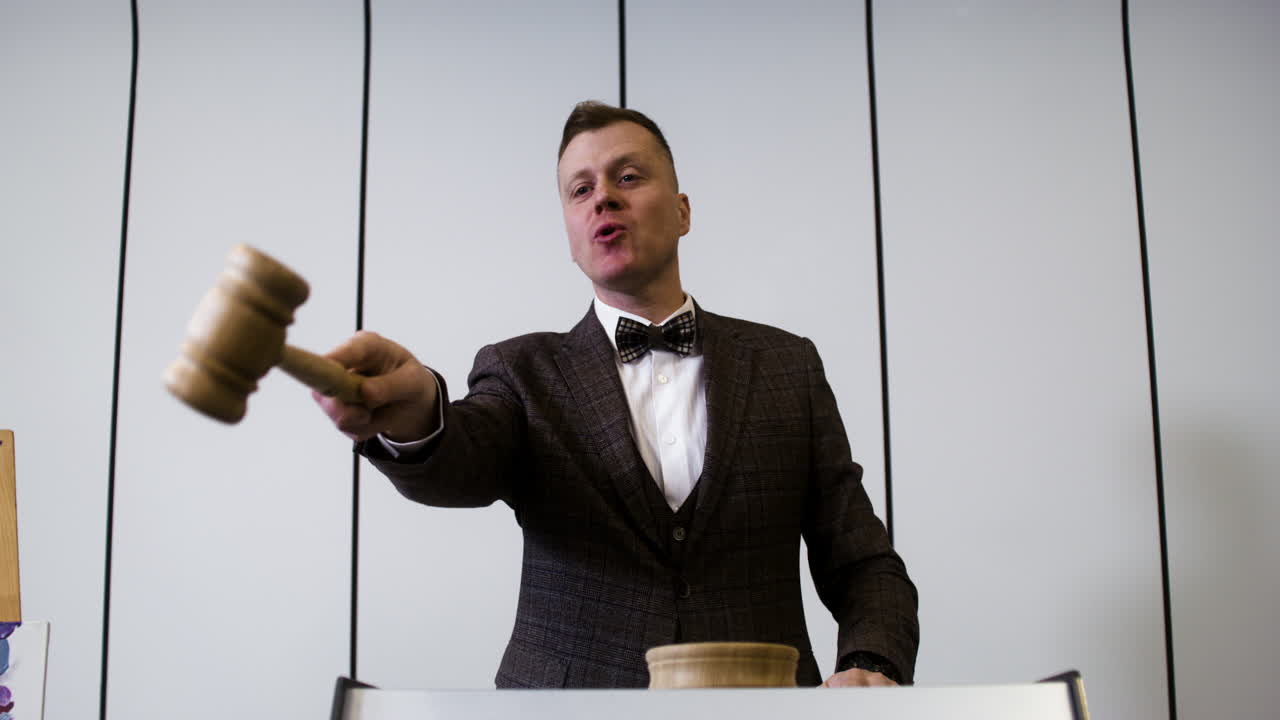 Man in elegant suit with gavel
