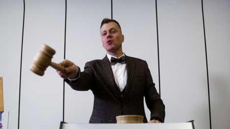 man in elegant suit with gavel