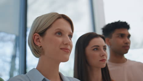 motivated group looking distance at big window office closeup. people listening