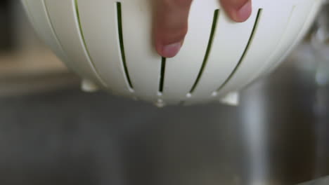 Close-Up-of-Female-Hands-Washing-Collinder-Under-Tap