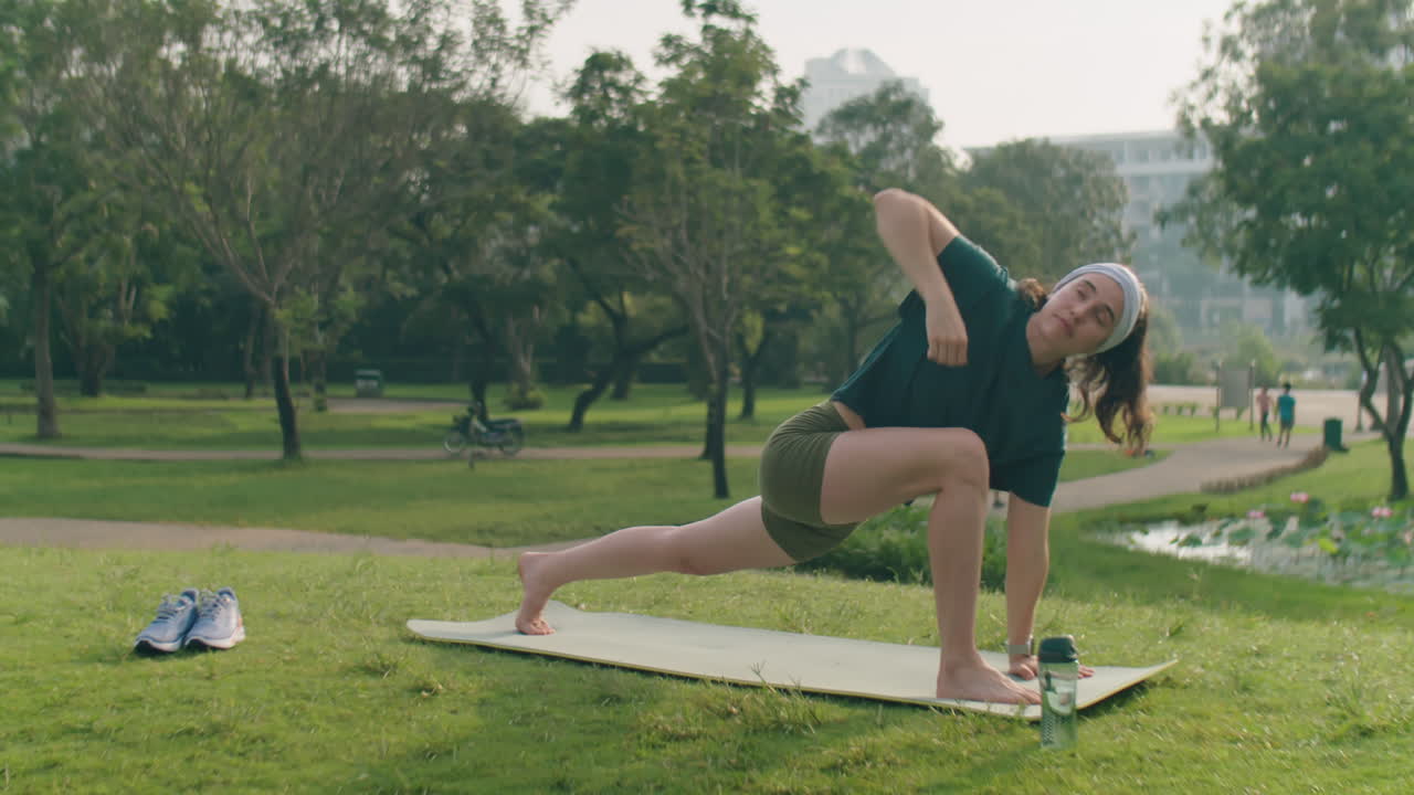 Woman Doing Vinyasa Yoga in Park