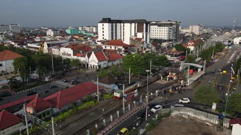 aerial footage, dense atmosphere of malioboro street yogyakarta, visible railway tracks of tugu station. main destination in yogyakarta.
