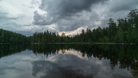 timelapse of clouds reflecting in a still lake on an overcast day