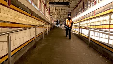 worker walking through melbourne train station walkway