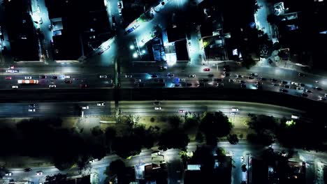 flying over main highway in mexico city at night time, residential area view