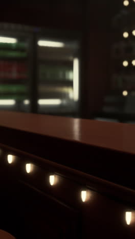 a dark bar counter with lights