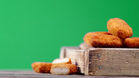 nuggets in a wooden tray on the table slowly rotates.