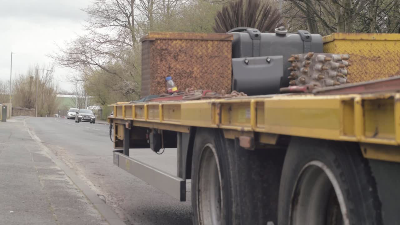Heavy plant industrial trailer parked on highway road medium panning shot