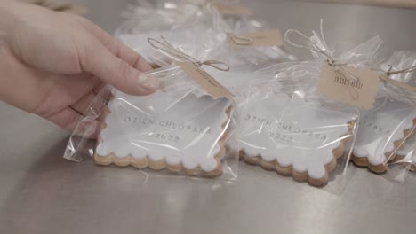 Handmade-butter-cookies-with-white-icing-and-custom-lettering-wrapped-in-cellophane-as-personalized-gift