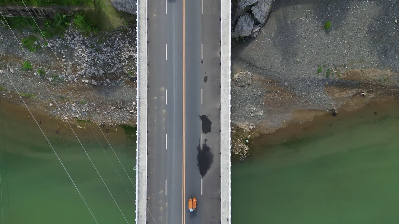 Aerial top-down flyover of provincial bridge with cars and motorcycles crossing at Santo Domingo, Virac, Catanduanes.