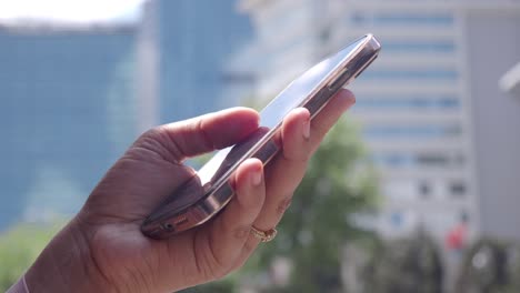 person using smartphone in a city