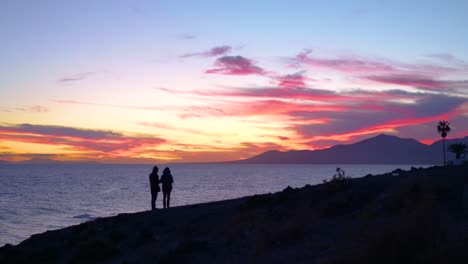 couple watching sunset over the ocean