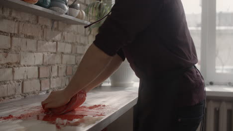 person working with clay in a pottery studio