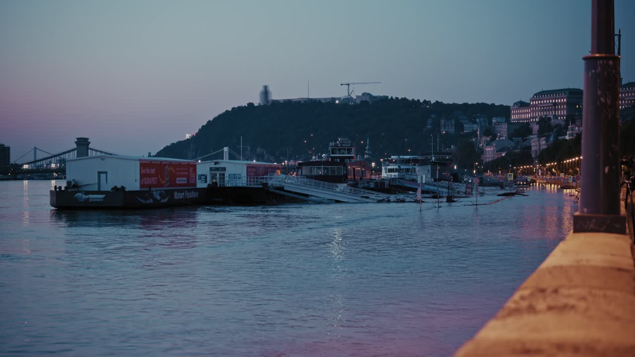 Flooded riverside with docked boats in Budapest, Hungary, during 2024 flood event