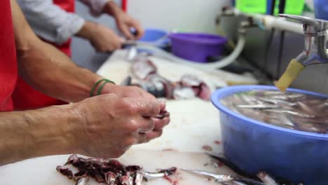 cleans and prepares fish for sale at market