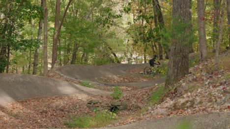 A-woman-riding-mountain-bike-berms-made-out-of-asphalt-in-bentonville-arkansas-on-her-santa-cruz-ebike