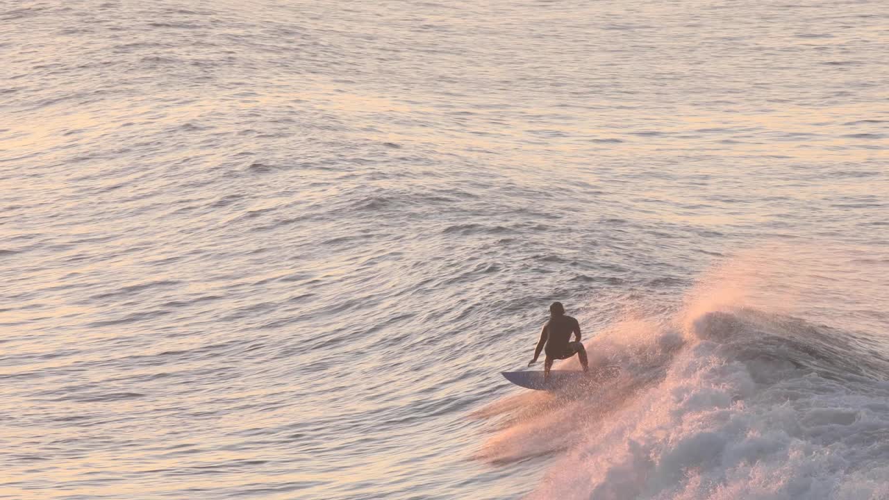 Surfer riding a cut wave at a popular beach in Surfers Paradise