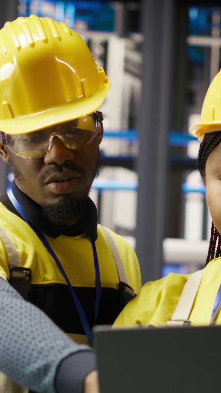 Vertical video Engineering team working together, overseeing solar panel production lines