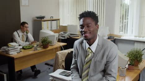 african american businessman smiling at camera.