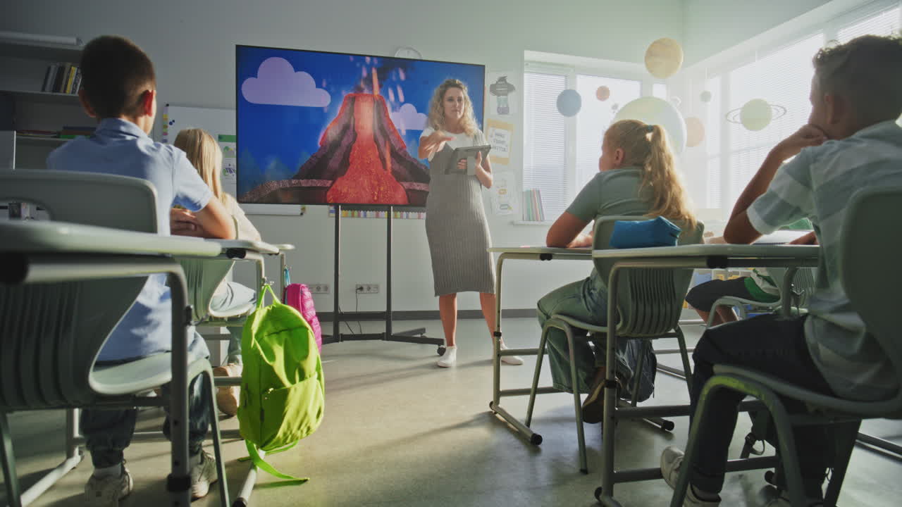 Geology Class Female Teacher Teaching Primary School Children Using Digital Screen