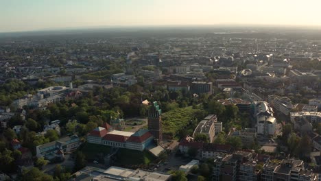 wide overview shot of jugendstil center mathildenhoehe in darmstadt with the down town city in the background with a drone on a sunny summer day