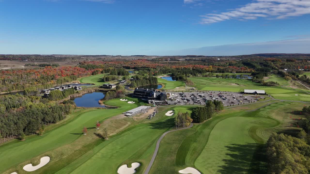 The drone flies high over the TPC Toronto clubhouse, revealing the scale of the facility, the beautiful water hazards, and the rolling autumn landscape of Ontario