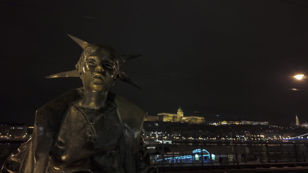 Bronze Little Princess statue on banks of Danube River, Budapest night