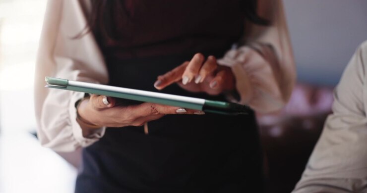 Colleagues Discussing Business Strategy Using a Digital Tablet