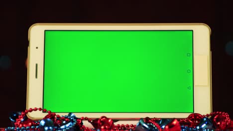 close up of a white tablet with a green screen for insertion.