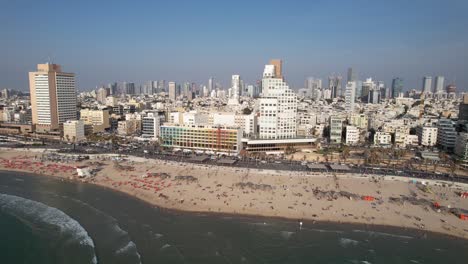 aerial view overlooking beaches and the cityscape of tel aviv, in sunny israel - pan, drone shot