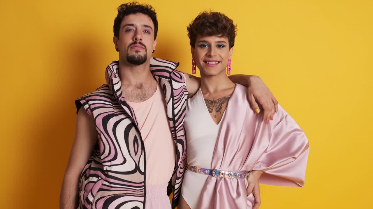 Gay man and transgender man posing together in a photographic studio