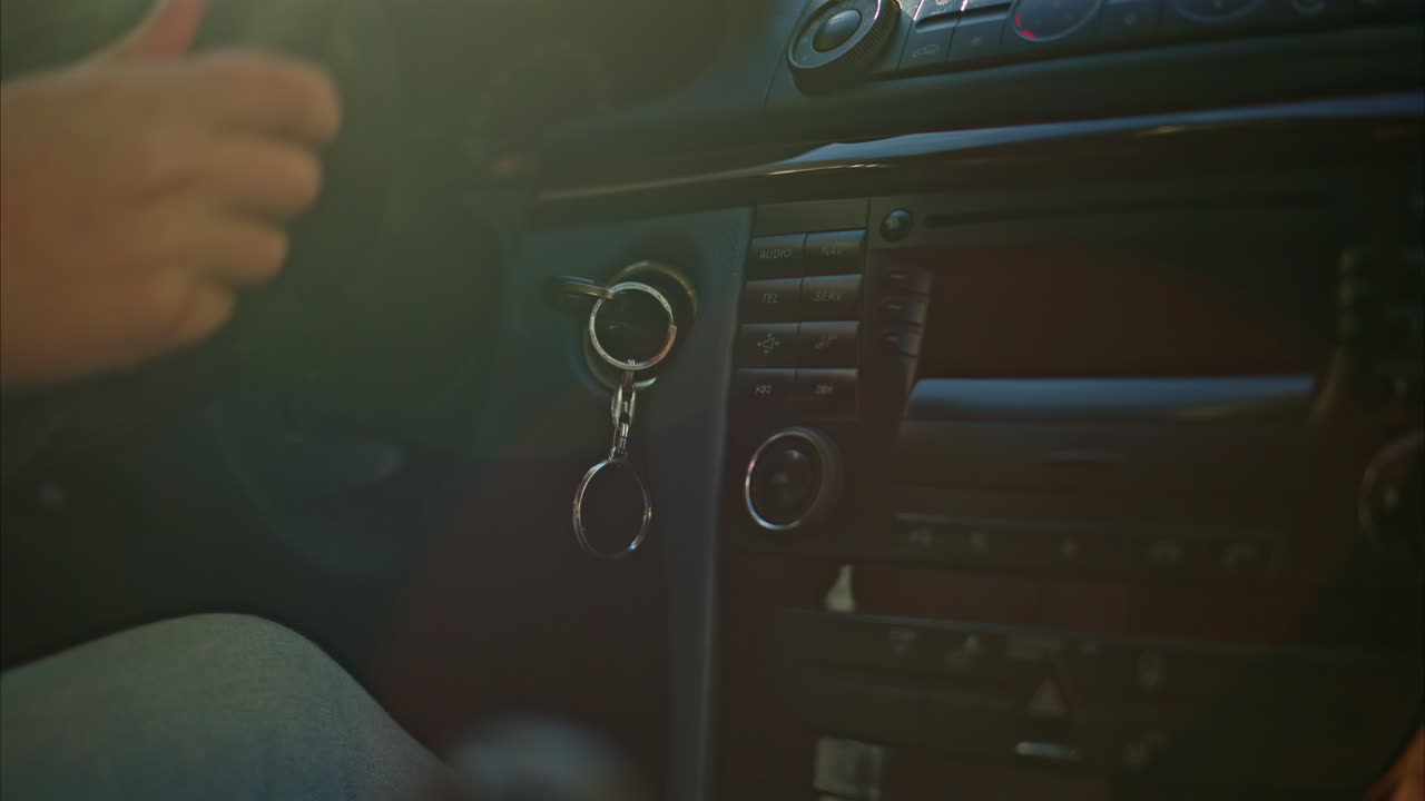Person shifting gears while driving a car in daylight