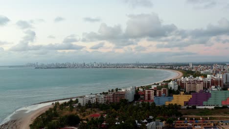 Beautiful-aerial-drone-shot-of-the-tropical-city-of-Joao-Pessoa-with-a-large-coastline-and-skyscrapers-in-the-distance-located-in-Northern-Brazil