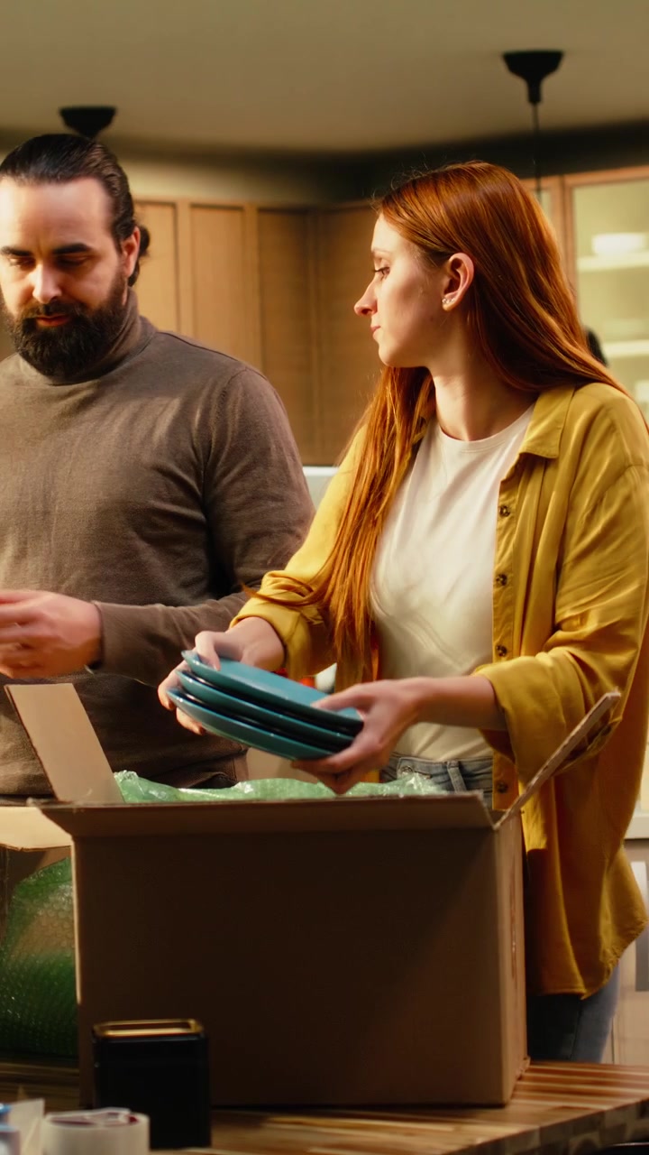 Vertical Video Partners unpacking wrapped furniture together to settle in first home