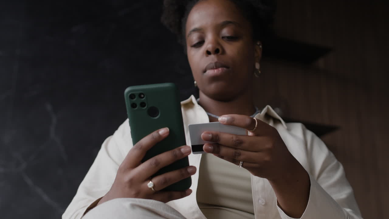 Woman using smartphone for online payment with credit card