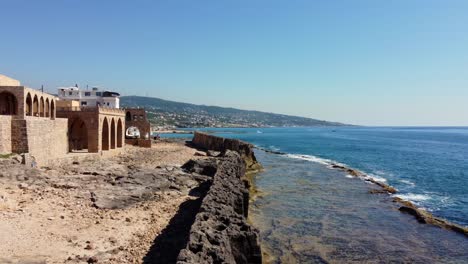 edificios frente al mar cerca de la muralla fenicia, antiguo malecón en batroun, líbano