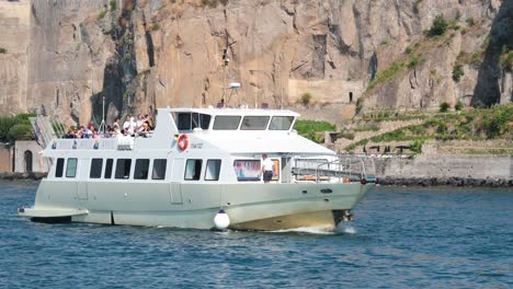 ship cruising along rocky naples coastline