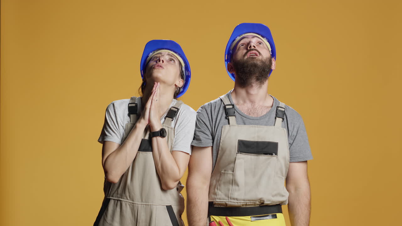 Portrait of construction workers praying for help
